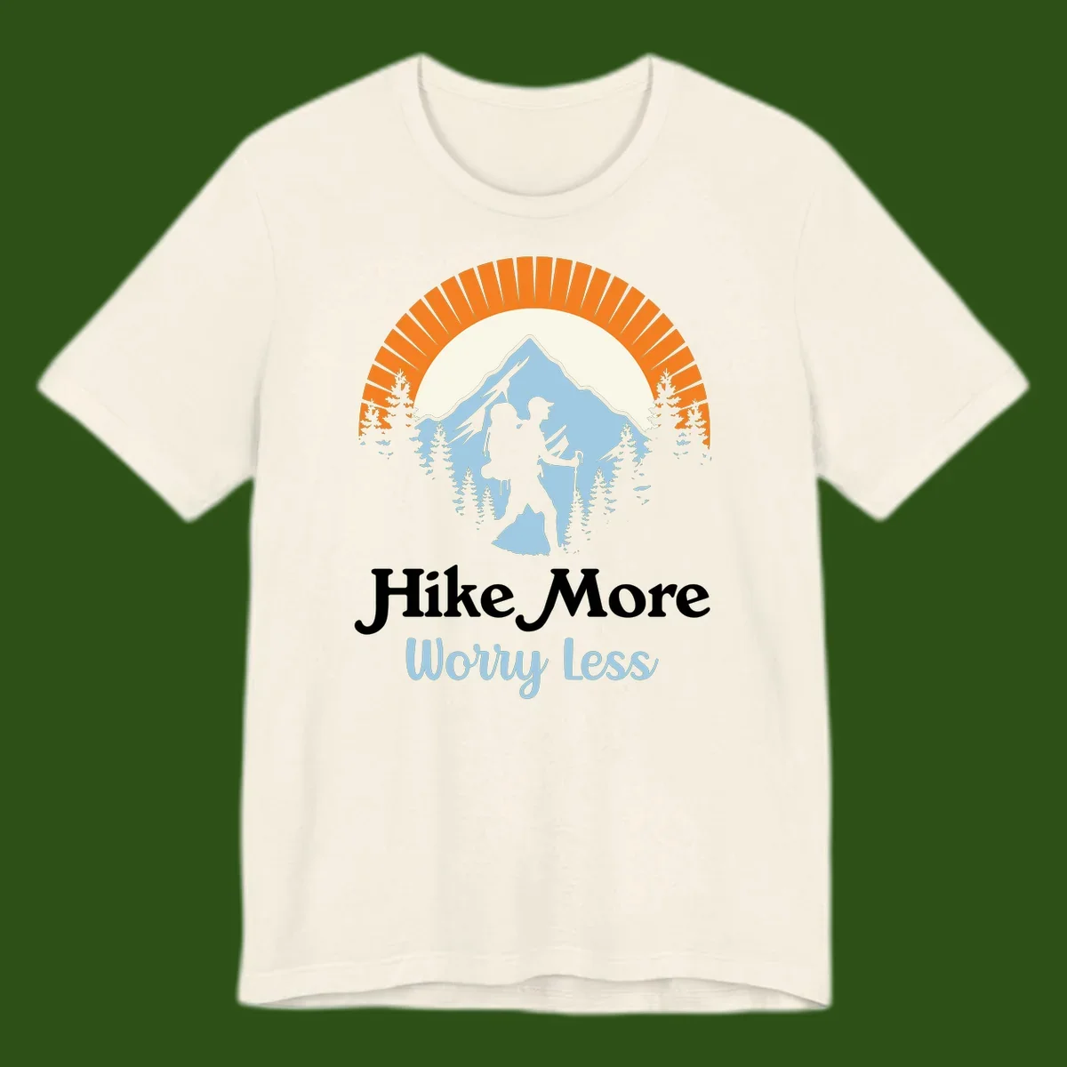 Hike more worry less badge design with silhouetted hiker, mountain peak, and evergreen forest in circular composition.