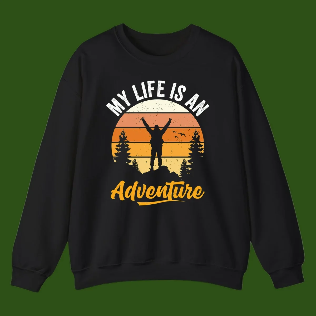 Retro sunset illustration with silhouette of person celebrating arms raised, evergreen trees and mountains, text 'My Life Is An Adventure'