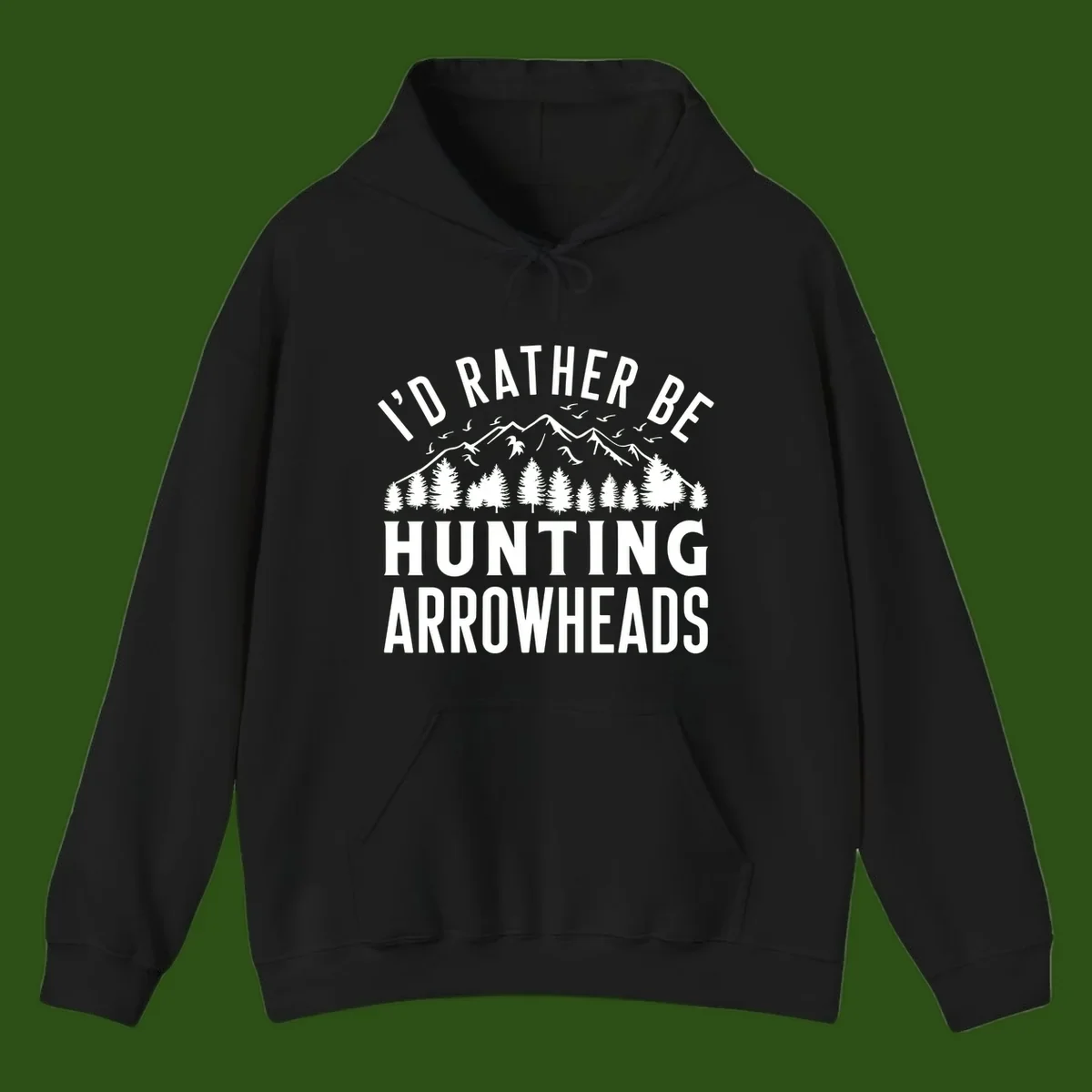 Mountain landscape with evergreen trees and birds, white text reading 'I'd Rather Be Hunting Arrowheads' on gray background