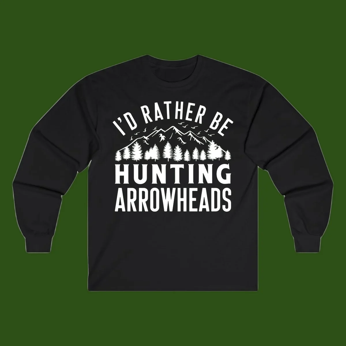 Mountain landscape with evergreen trees and birds, white text reading 'I'd Rather Be Hunting Arrowheads' on gray background
