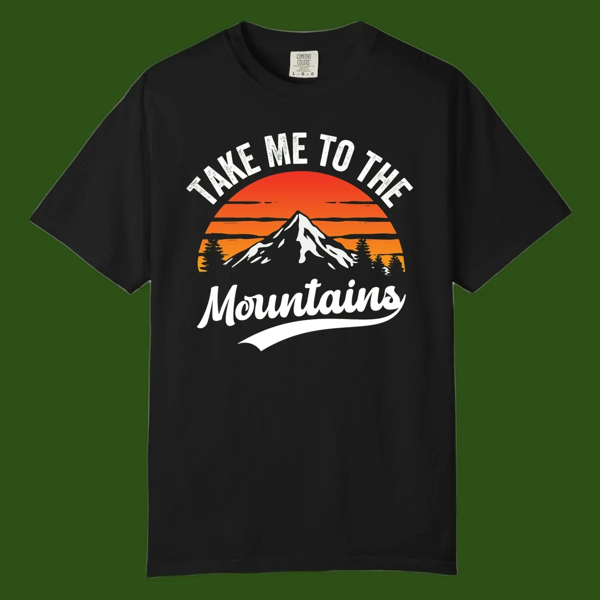 Vintage-style illustration of snow-capped mountain with sunset stripes and evergreen trees, text reading 'Take Me To The Mountains'