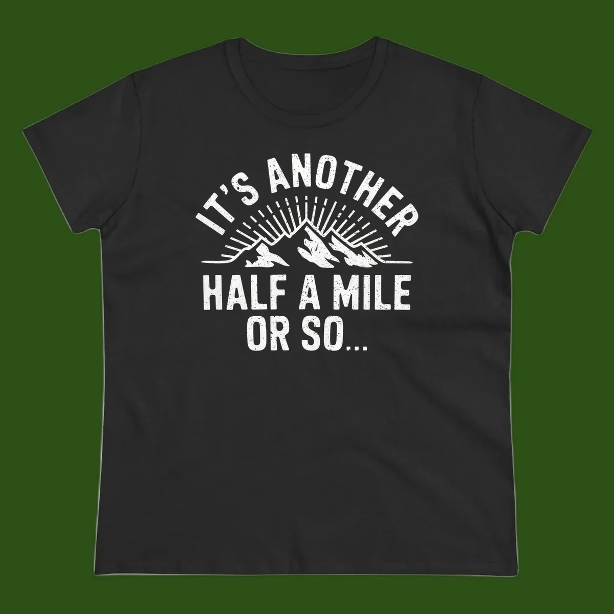 Retro distressed design with mountain peaks and sun rays, text reads 'It's Another Half A Mile Or So' - humorous hiking and camping artwork