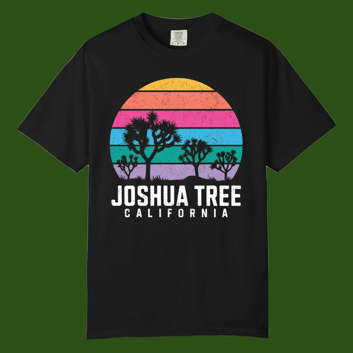 Joshua tree desert stripes design with silhouetted trees across rainbow horizontal color bands and distressed texture.