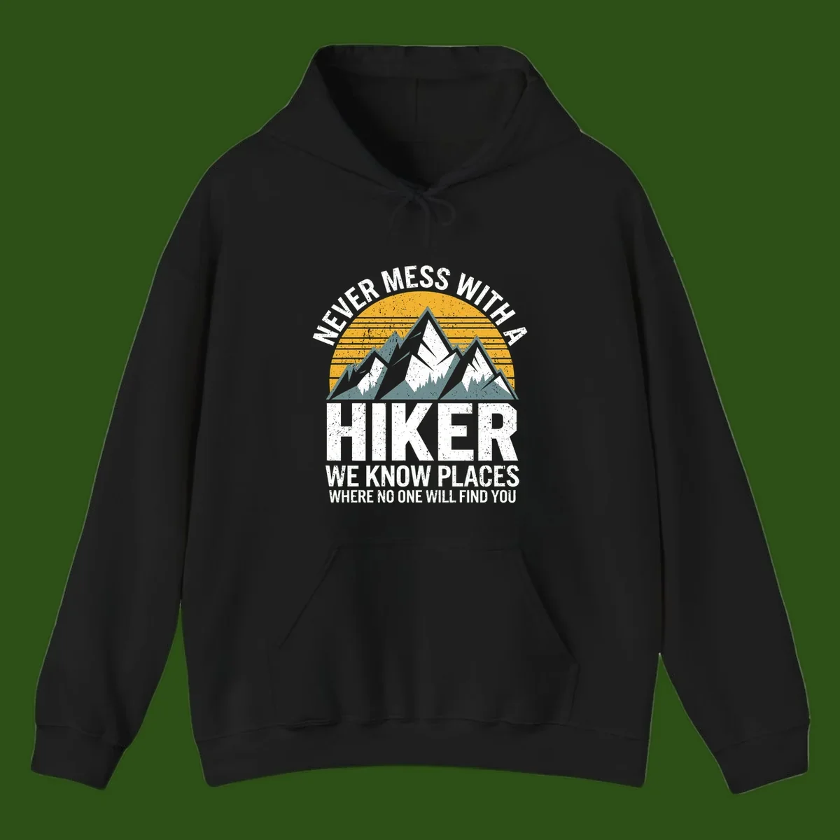 Vintage-style design with snow-capped mountains and forest silhouette against striped sunset, text reads 'Never Mess With A Hiker We Know Places Where No One Will Find You'