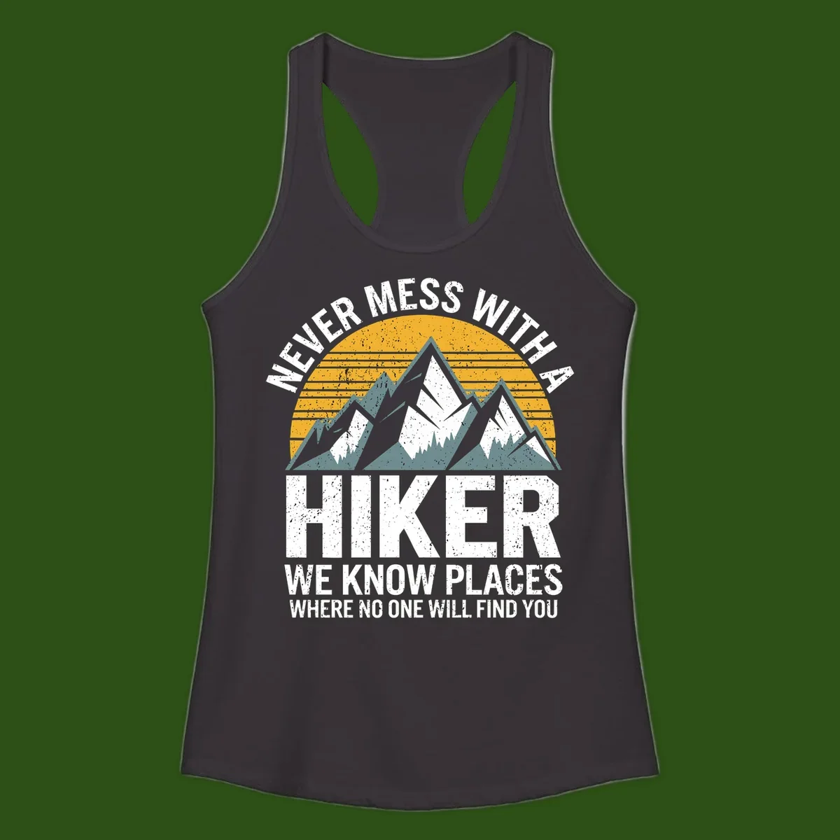 Vintage-style design with snow-capped mountains and forest silhouette against striped sunset, text reads 'Never Mess With A Hiker We Know Places Where No One Will Find You'