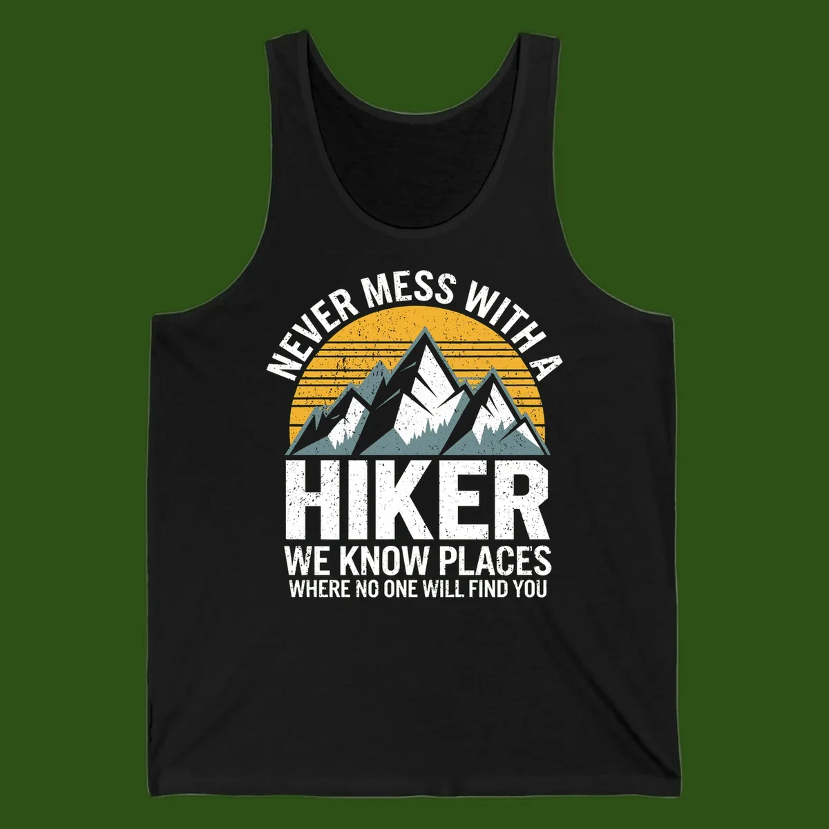 Vintage-style design with snow-capped mountains and forest silhouette against striped sunset, text reads 'Never Mess With A Hiker We Know Places Where No One Will Find You'