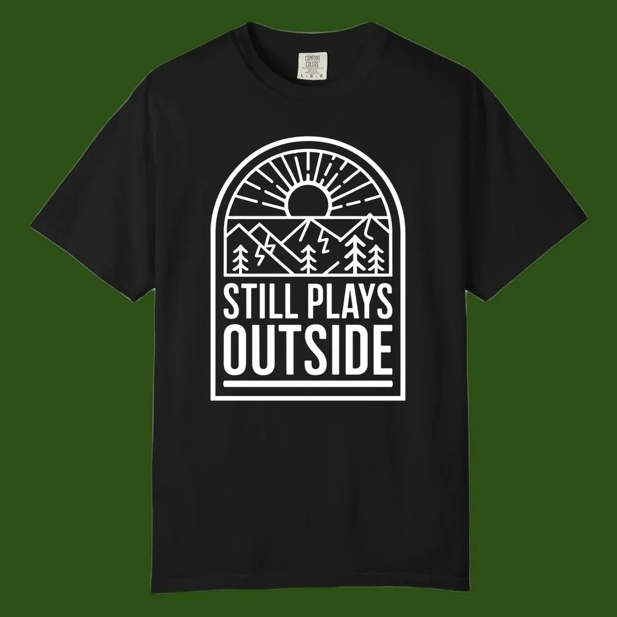 Still Plays Outside badge design featuring mountains, sun, pine trees, and lightning bolt in minimalist line art style