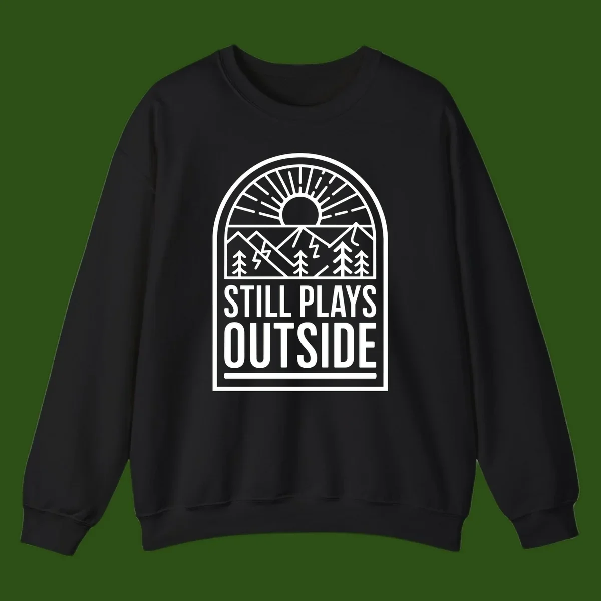 Still Plays Outside badge design featuring mountains, sun, pine trees, and lightning bolt in minimalist line art style