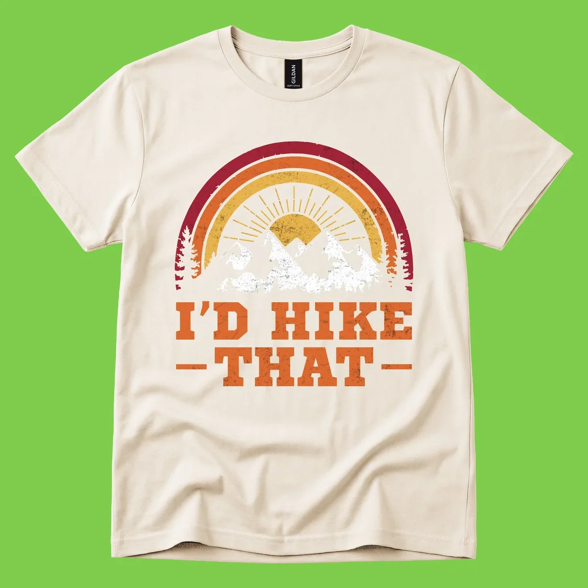Vintage badge design with snow-capped mountains, evergreen trees, golden sun rays, and text reading 'I'd Hike That' in retro style