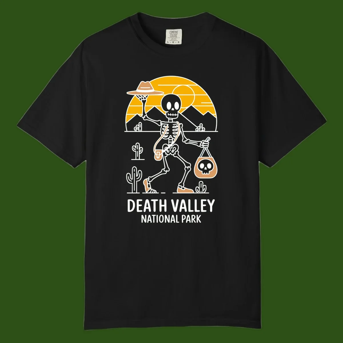 Skeleton cowboy holding skull pouch in Death Valley desert landscape with cacti, mountains, and golden sun rays