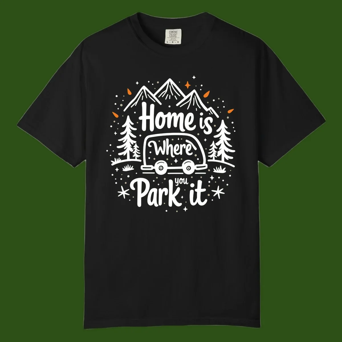 Illustrated winter camping scene with travel trailer, mountains, trees, and snowflakes with text 'Home is Where you Park it'