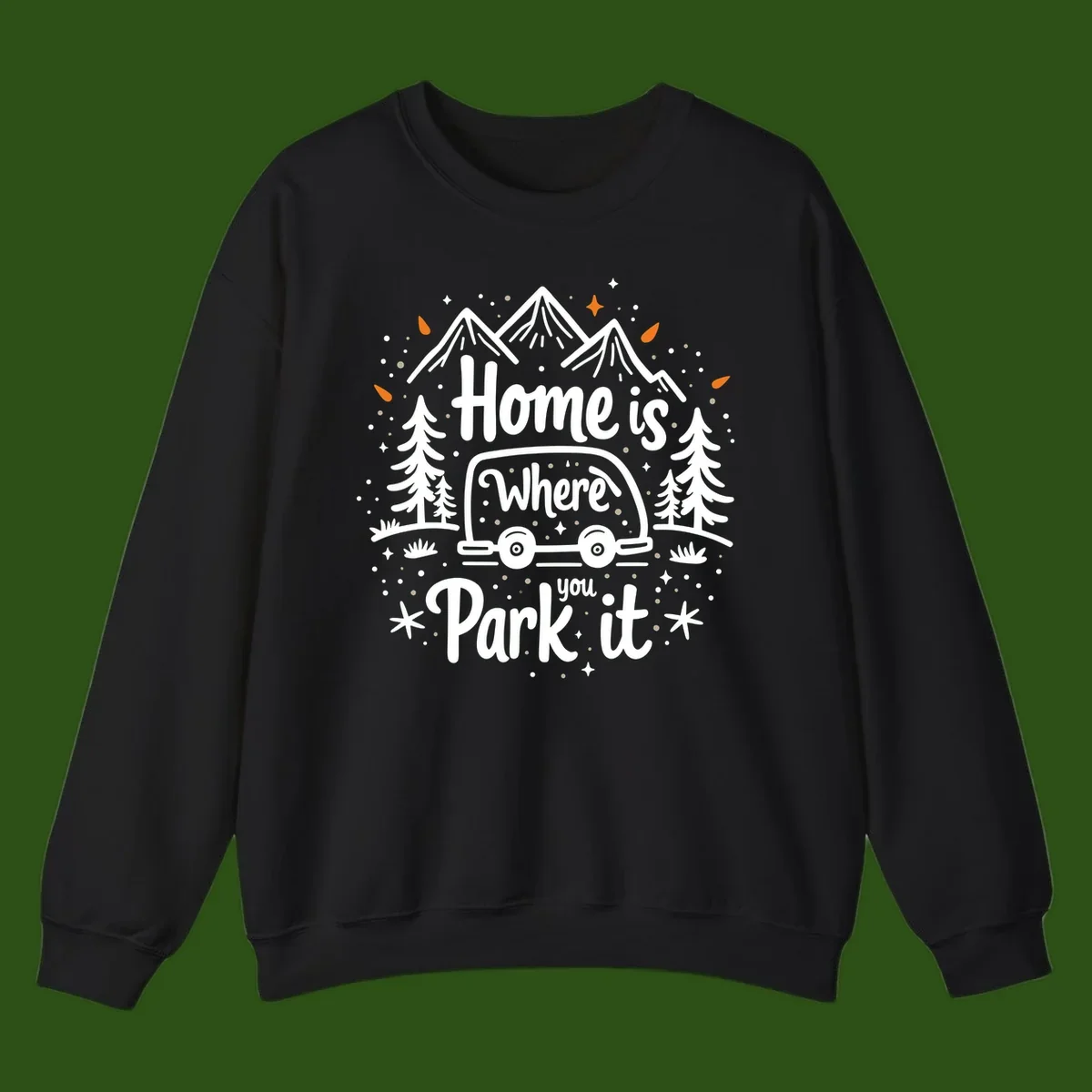 Illustrated winter camping scene with travel trailer, mountains, trees, and snowflakes with text 'Home is Where you Park it'