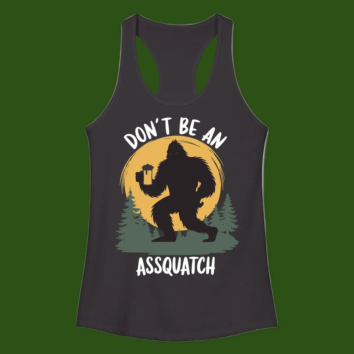 Black silhouette of Bigfoot holding a beer mug under a full moon with pine trees, text reads don't be an assquatch