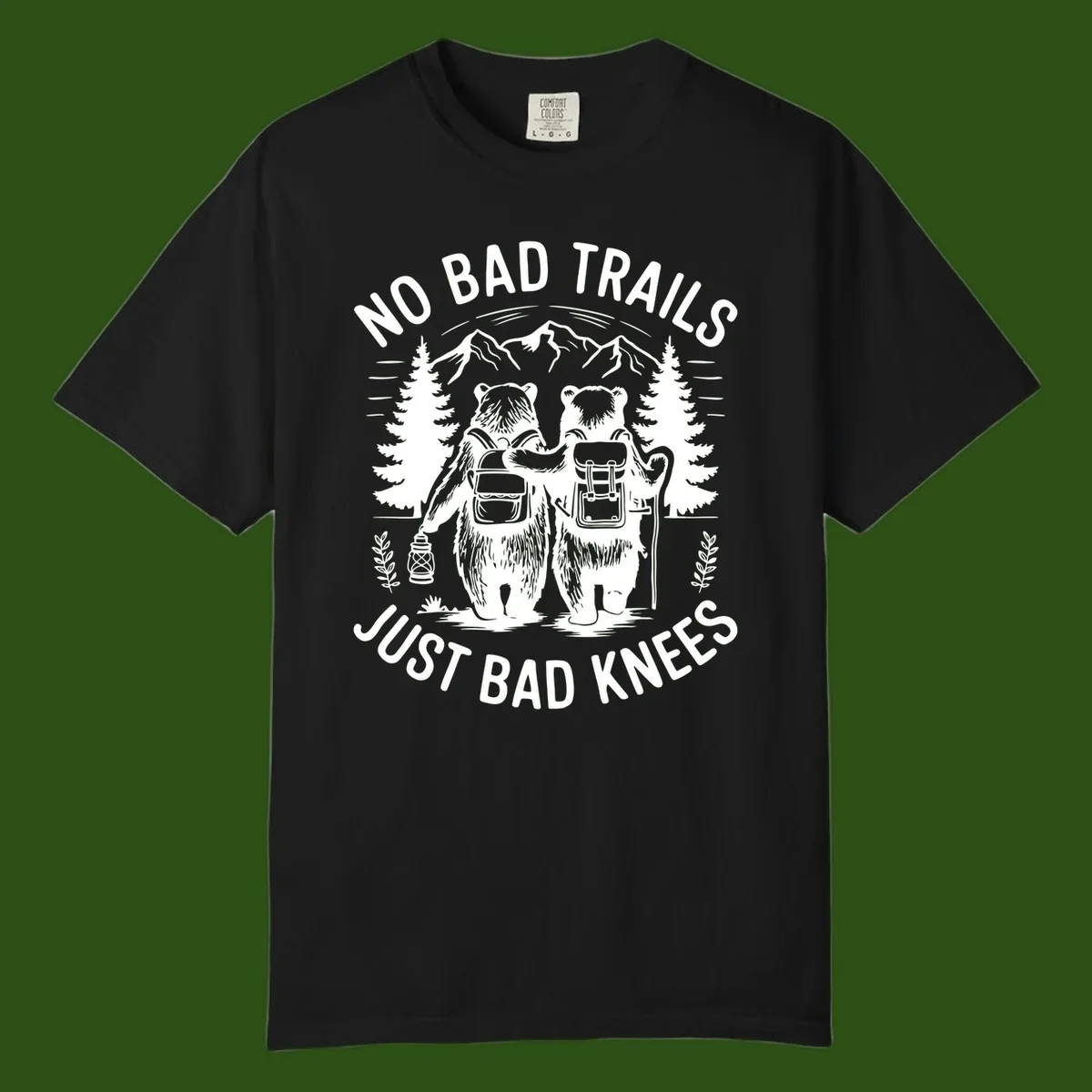 Two cartoon bears with backpacks hiking in mountains with text 'No Bad Trails Just Bad Knees' - humorous outdoor camping design