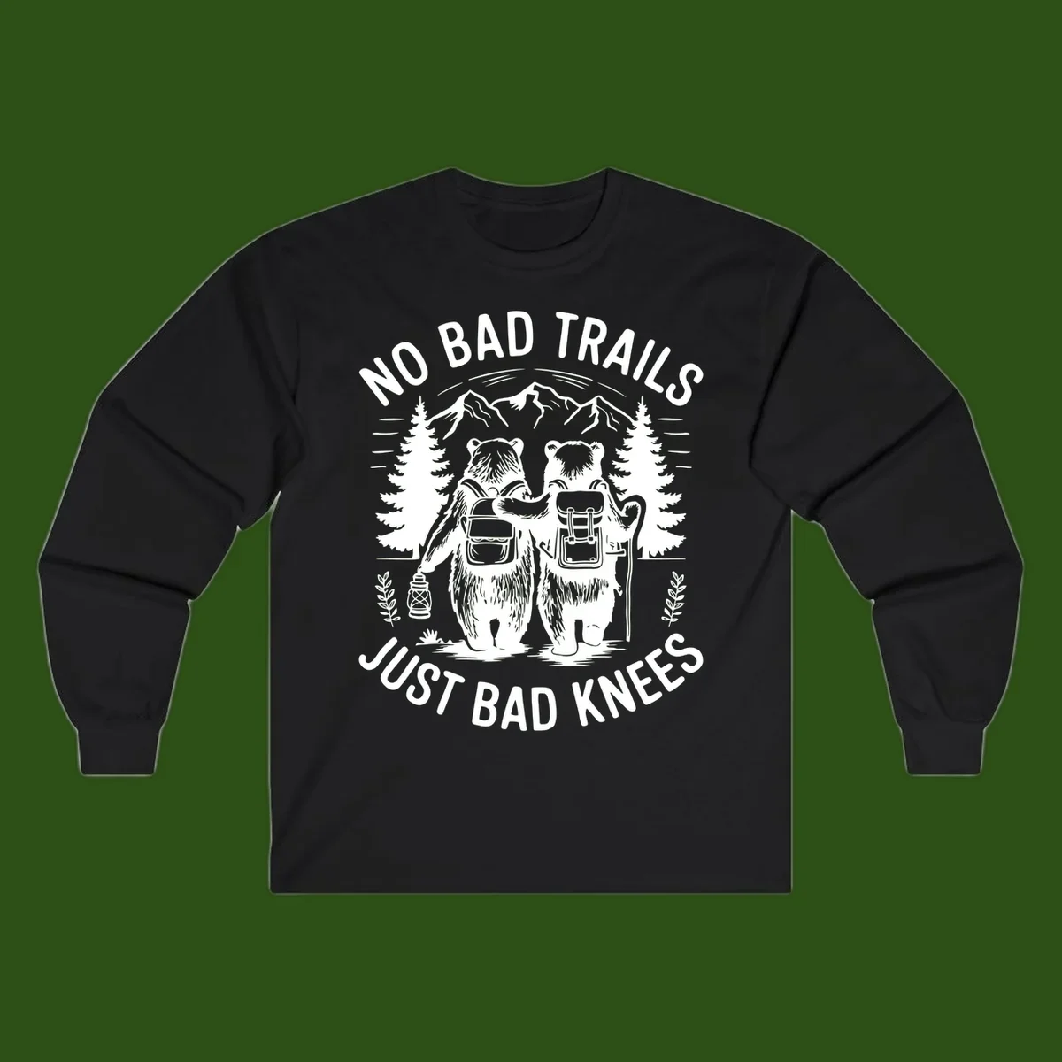 Two cartoon bears with backpacks hiking in mountains with text 'No Bad Trails Just Bad Knees' - humorous outdoor camping design
