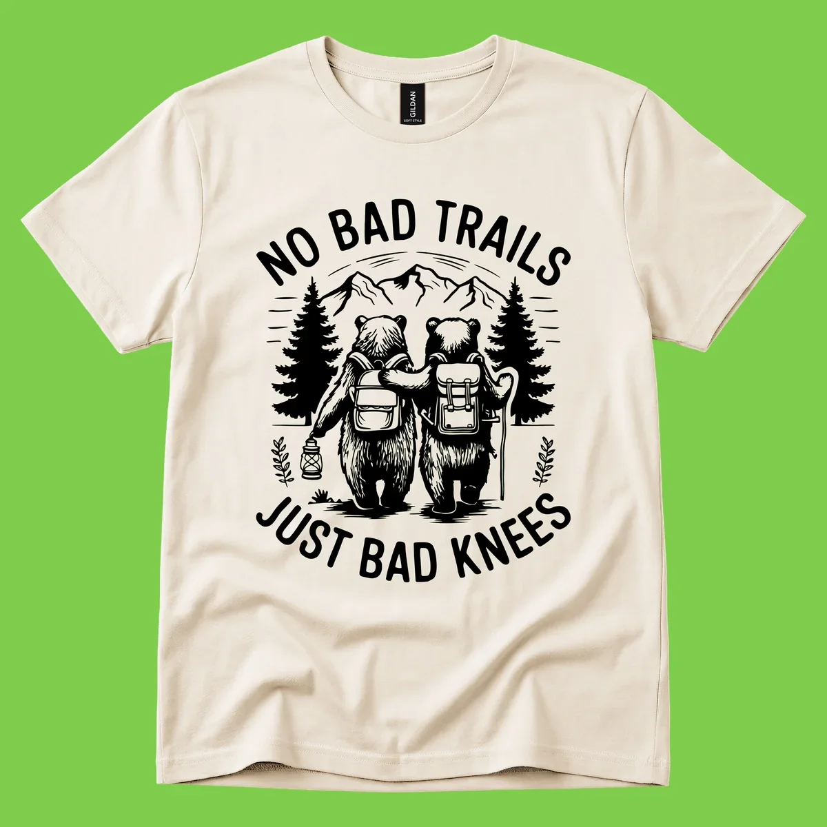 Two cartoon bears with backpacks hiking in mountains with text 'No Bad Trails Just Bad Knees' - humorous outdoor camping design