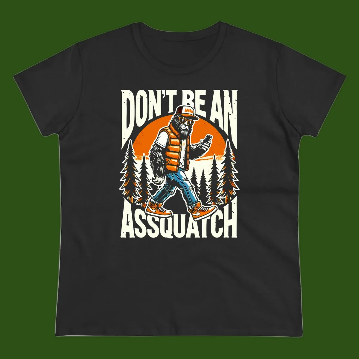 Cartoon sasquatch in hiking gear with backpack and smartphone, 'Don't Be An Assquatch' text, forest and orange sun background.
