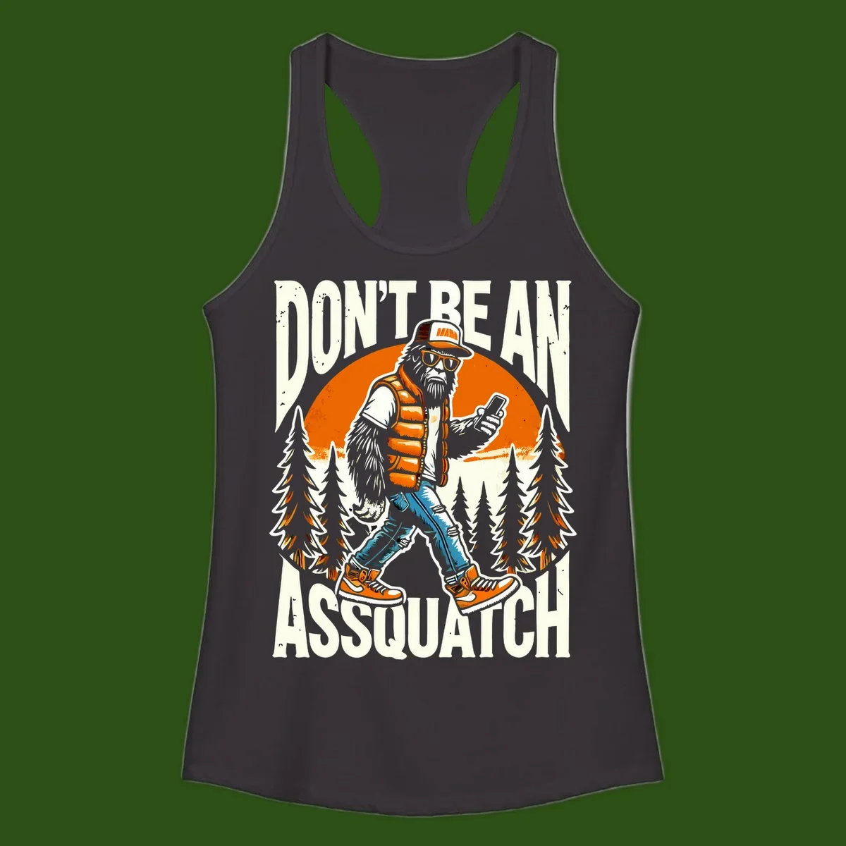 Cartoon sasquatch in hiking gear with backpack and smartphone, 'Don't Be An Assquatch' text, forest and orange sun background.