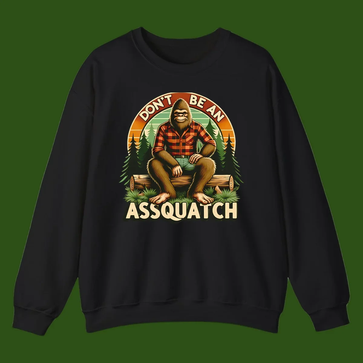 Vintage badge design with friendly Bigfoot in plaid shirt sitting on a log with forest trees, text reads 'Don't Be An Assquatch'