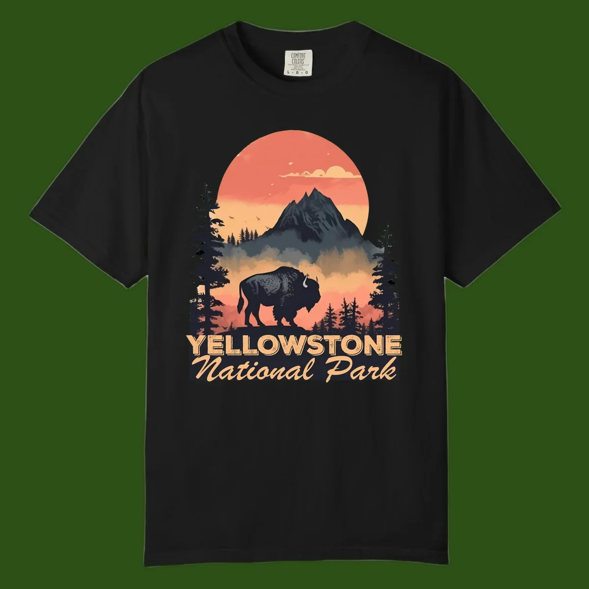 Yellowstone bison national park design: silhouette of a bison in misty forest with mountain peak and sunset sky
