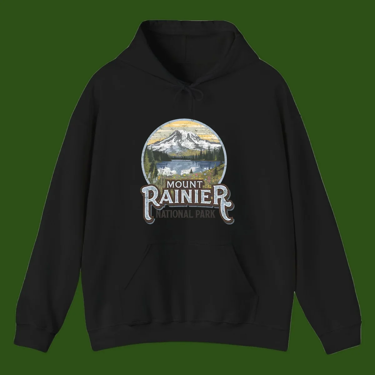 Vintage Mount Rainier National Park badge design with snow-capped peak, alpine lake, evergreen forest, and wildflowers on distressed background