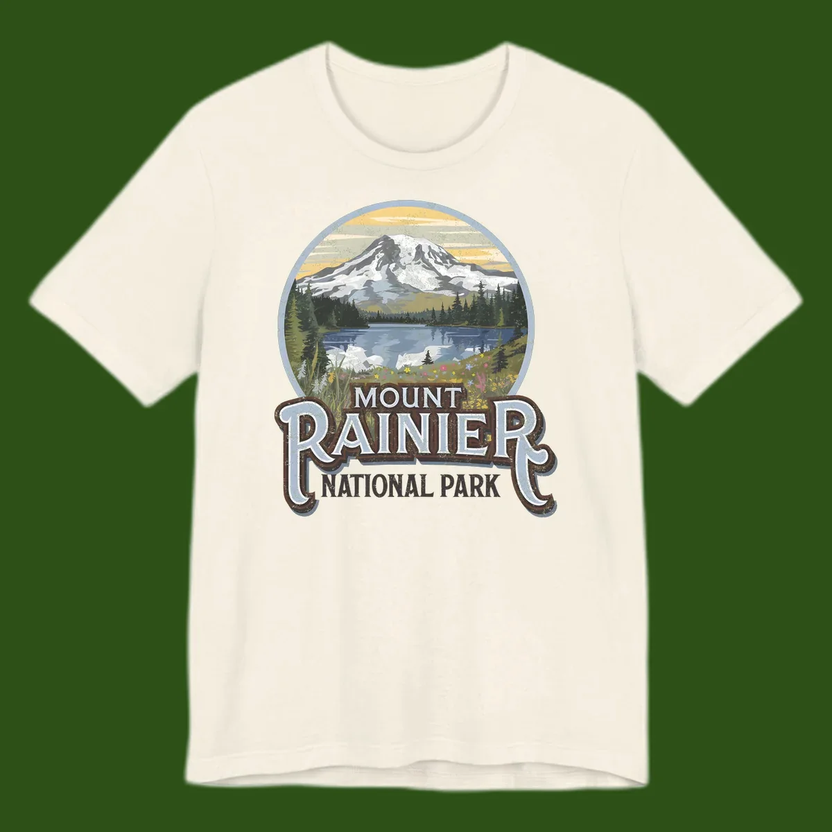 Vintage Mount Rainier National Park badge design with snow-capped peak, alpine lake, evergreen forest, and wildflowers on distressed background