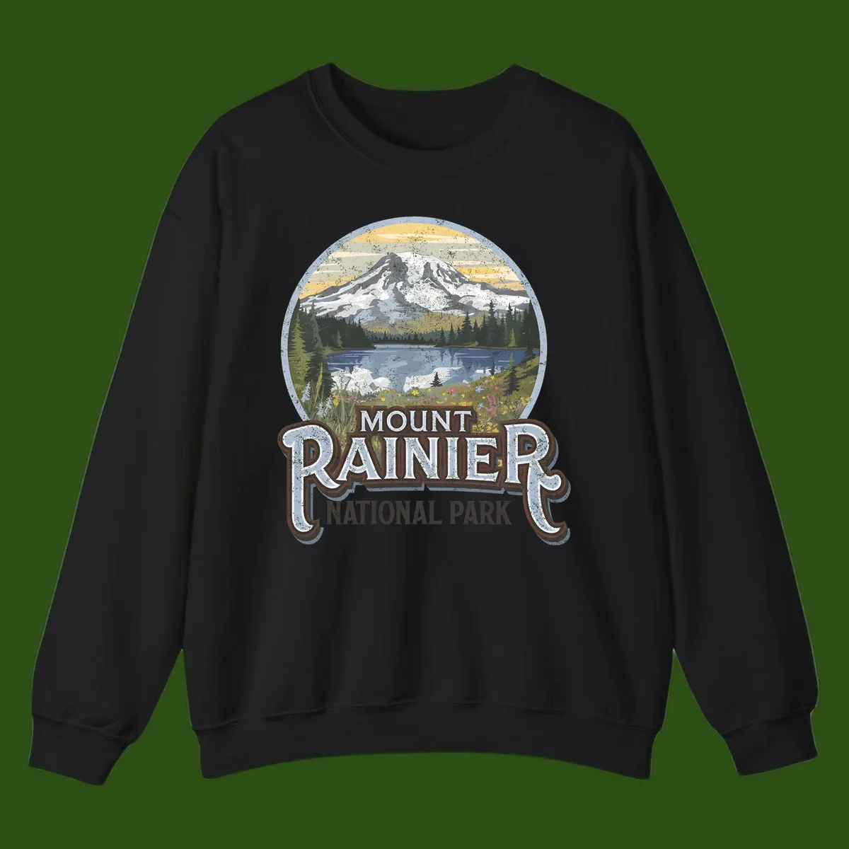 Vintage Mount Rainier National Park badge design with snow-capped peak, alpine lake, evergreen forest, and wildflowers on distressed background