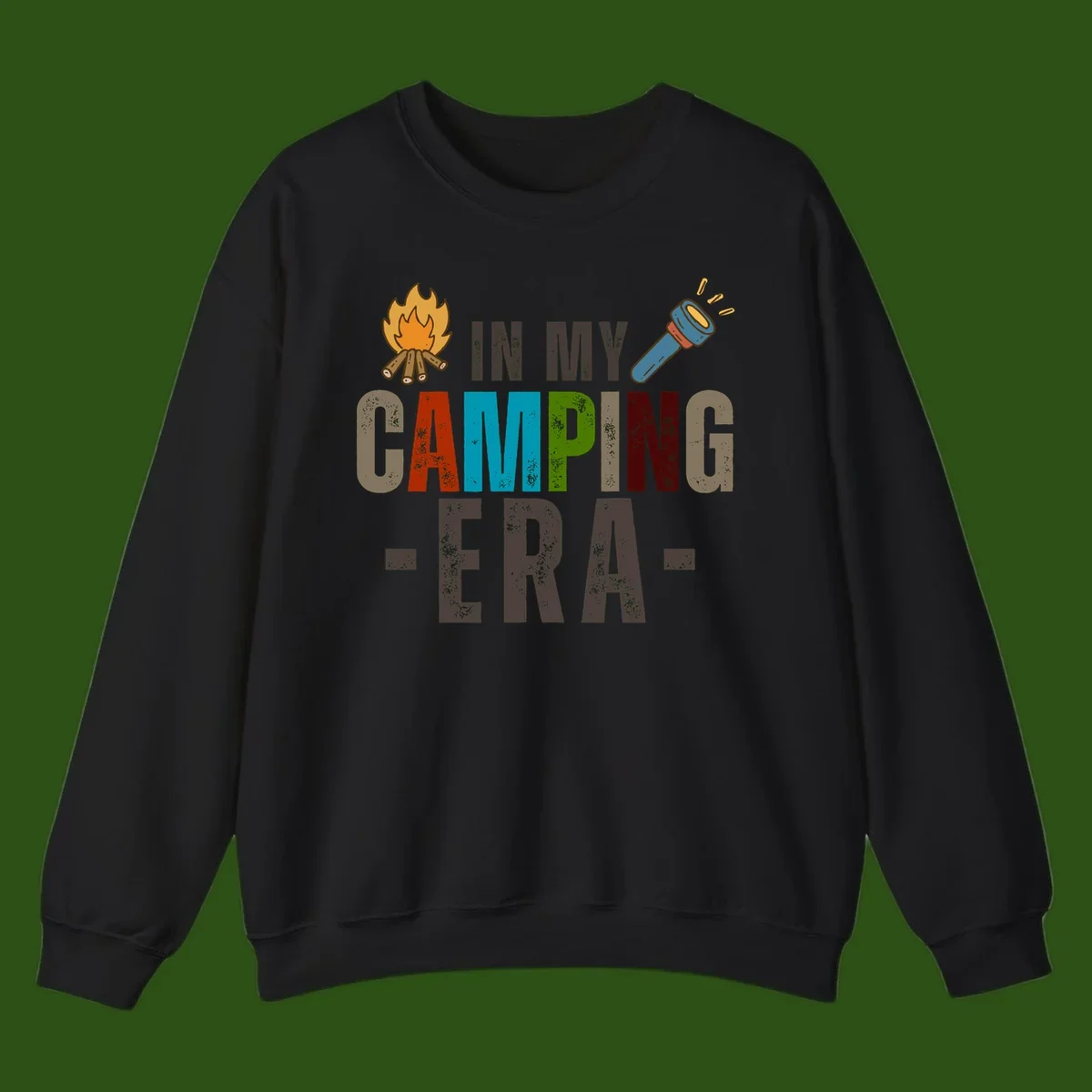 Campfire and flashlight icons flank colorful distressed text reading 'In My Camping Era' on gray background