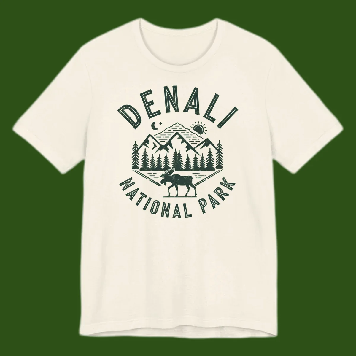Denial National Park badge design with moose walking through forest, mountains, sun and moon with crossed fishing rods