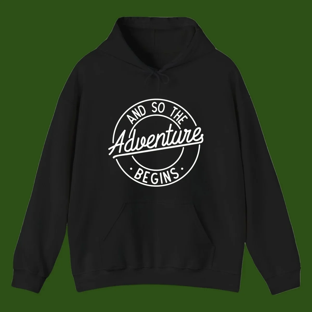 Vintage circular badge design with white text reading 'And So The Adventure Begins' on gray background