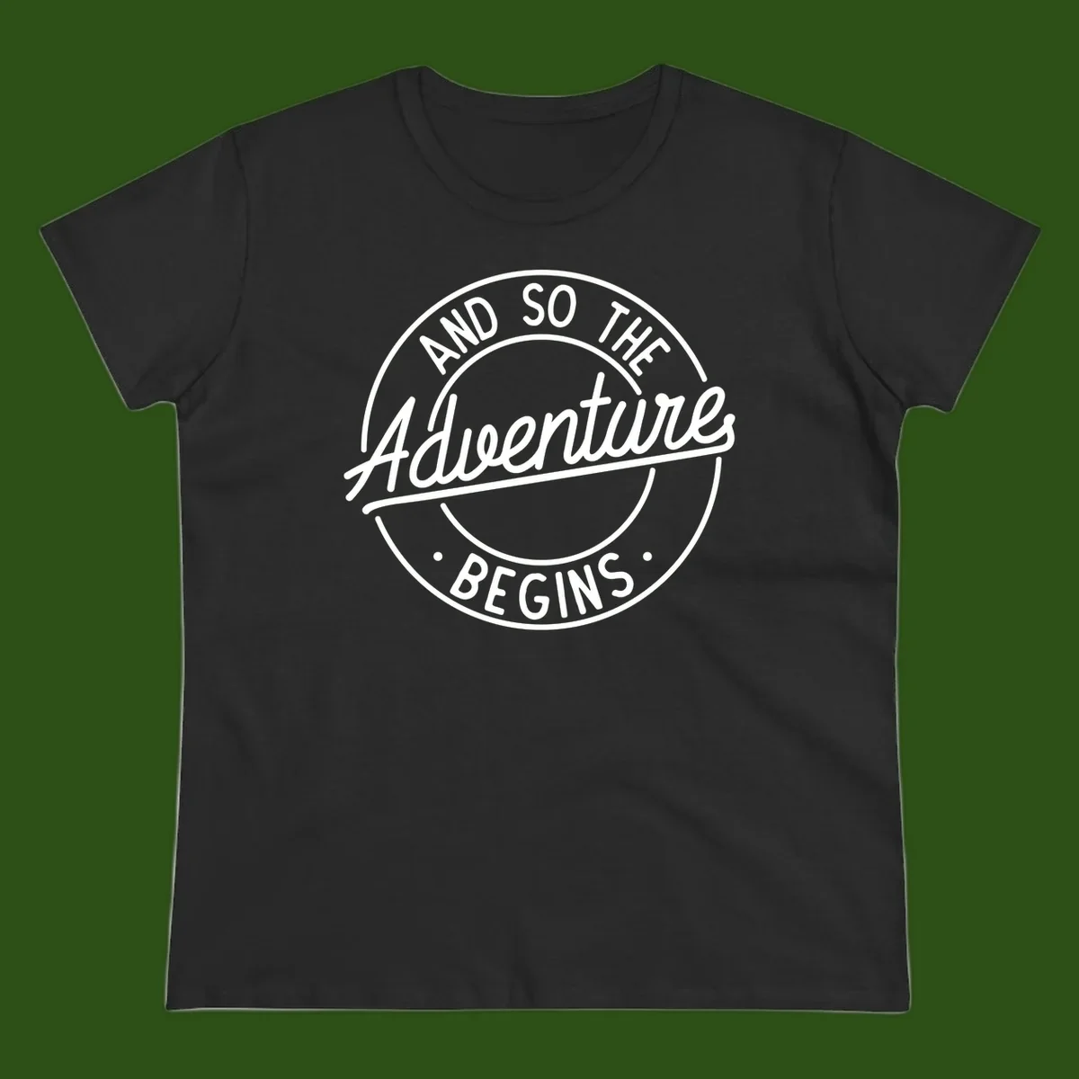 Vintage circular badge design with white text reading 'And So The Adventure Begins' on gray background