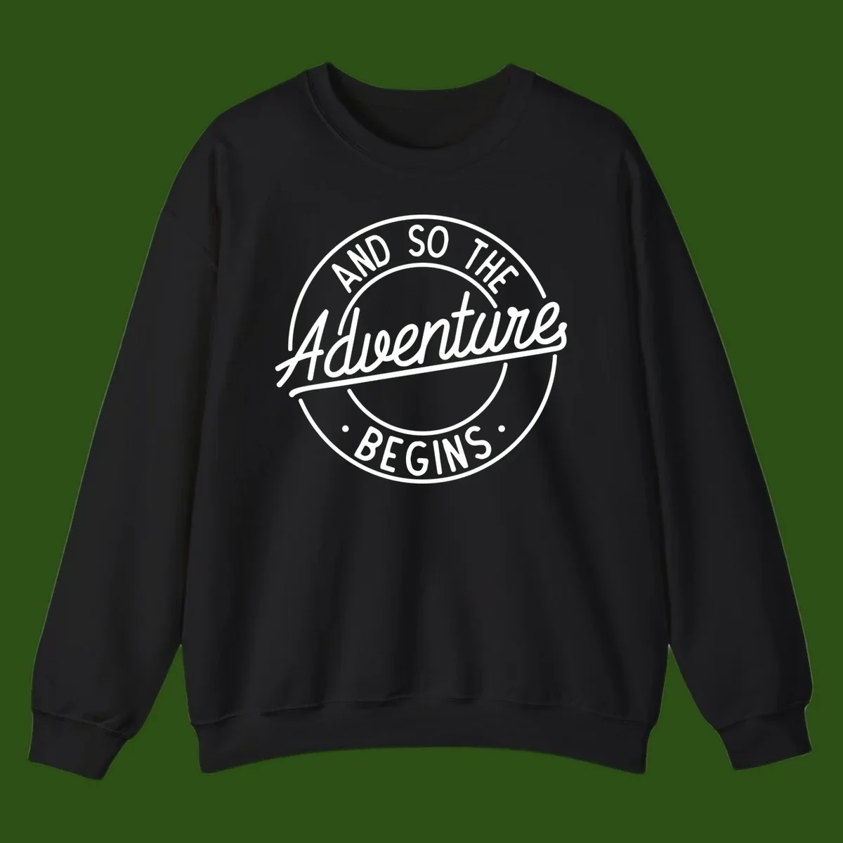 Vintage circular badge design with white text reading 'And So The Adventure Begins' on gray background
