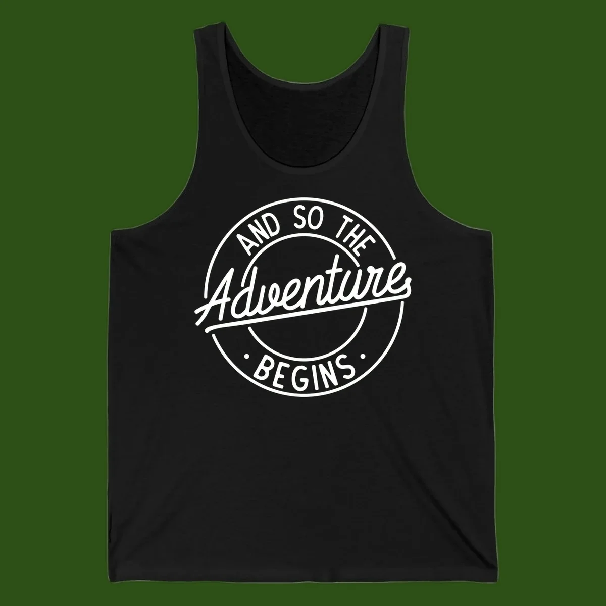 Vintage circular badge design with white text reading 'And So The Adventure Begins' on gray background