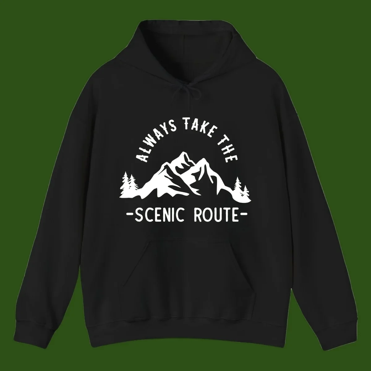 Mountain landscape with evergreen trees and text reading 'Always Take The Scenic Route' in bold lettering