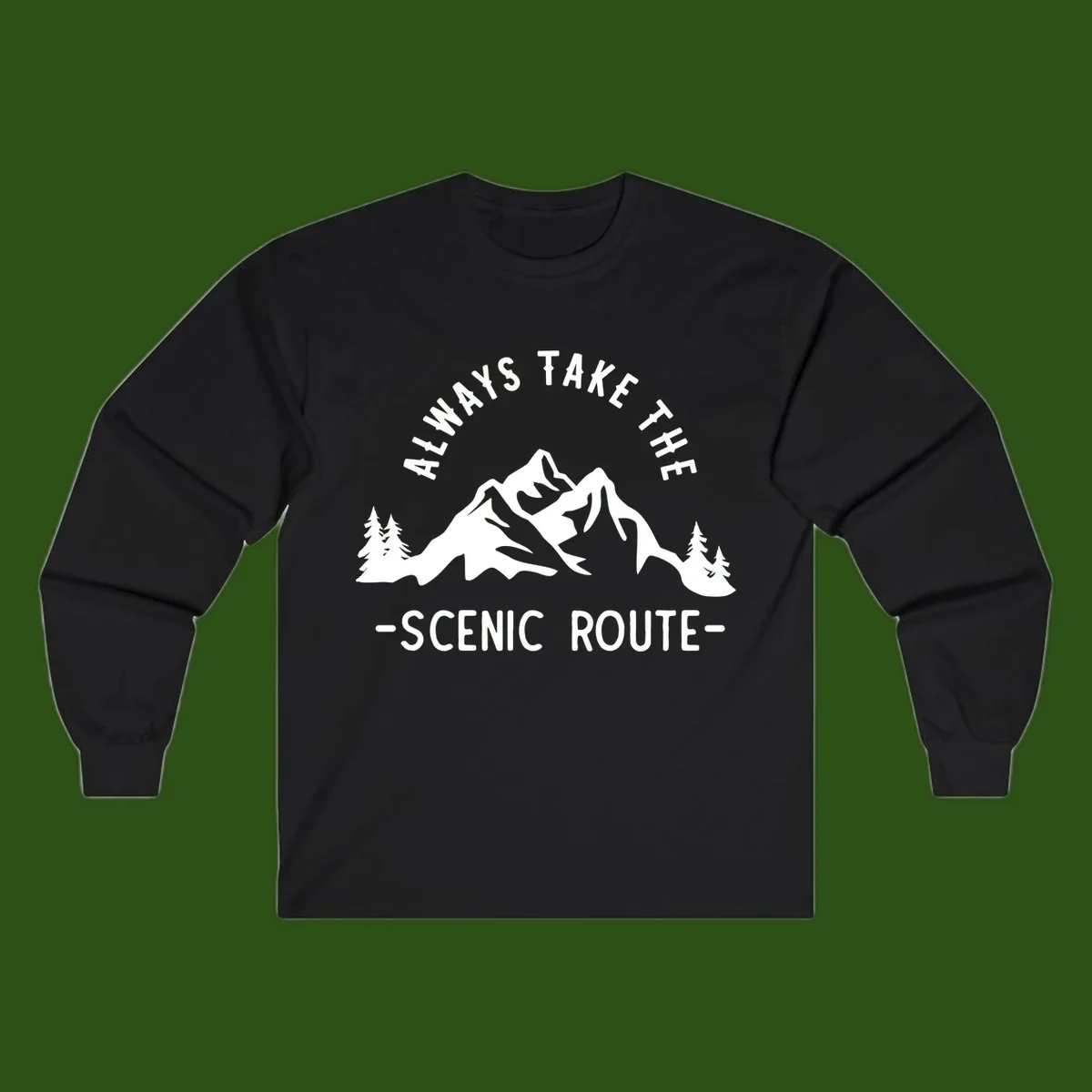 Mountain landscape with evergreen trees and text reading 'Always Take The Scenic Route' in bold lettering