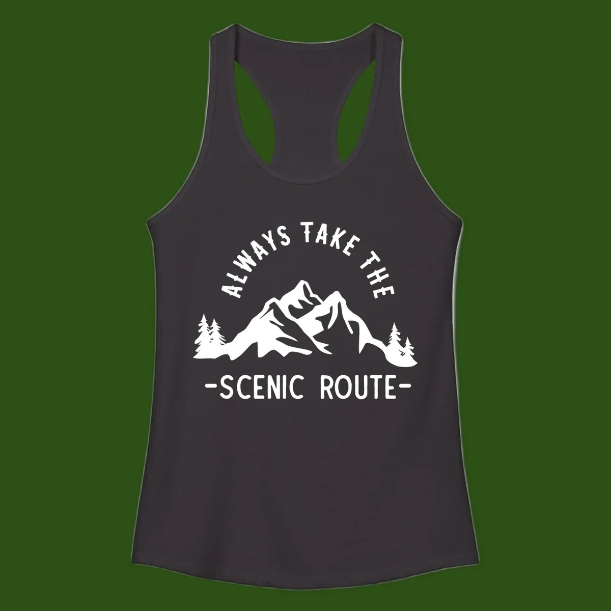 Mountain landscape with evergreen trees and text reading 'Always Take The Scenic Route' in bold lettering