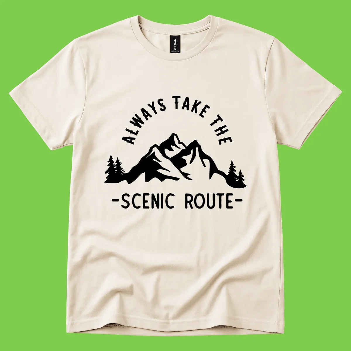Mountain landscape with evergreen trees and text reading 'Always Take The Scenic Route' in bold lettering
