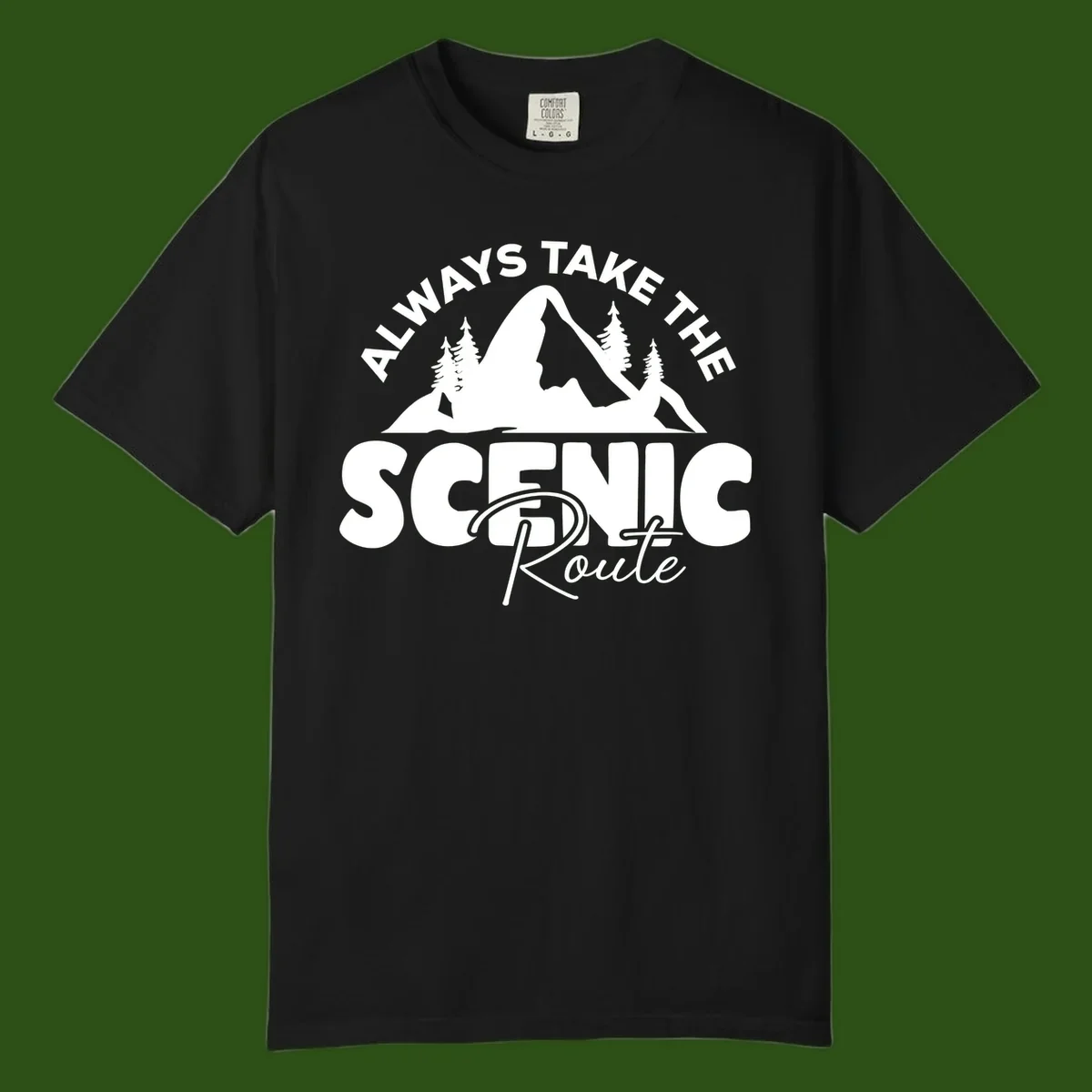 White mountain landscape illustration with evergreen trees and text reading 'All Ways Take The Scenic Route' on gray background