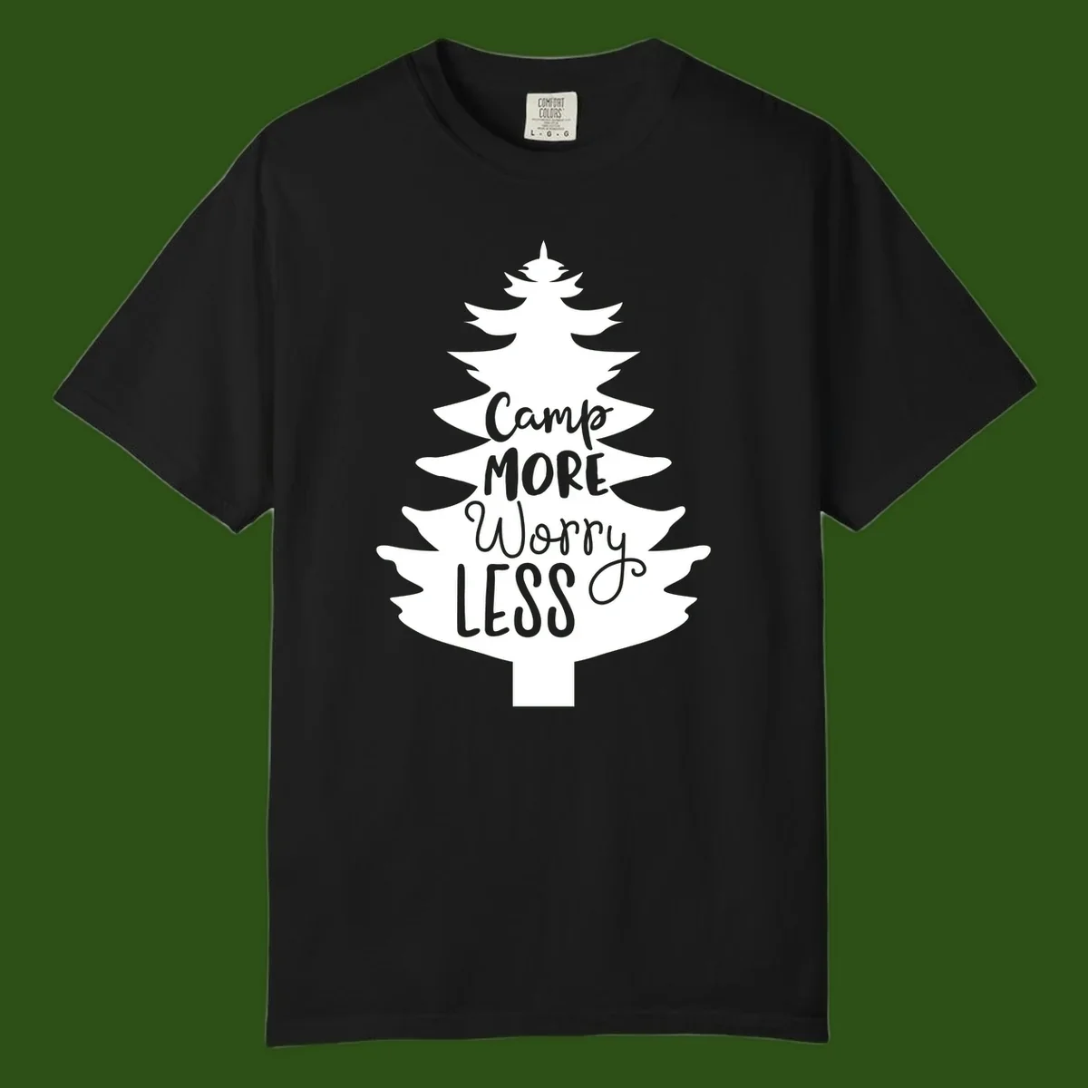 White evergreen tree silhouette with text reading 'Camp MORE Worry LESS' centered in the branches on gray background