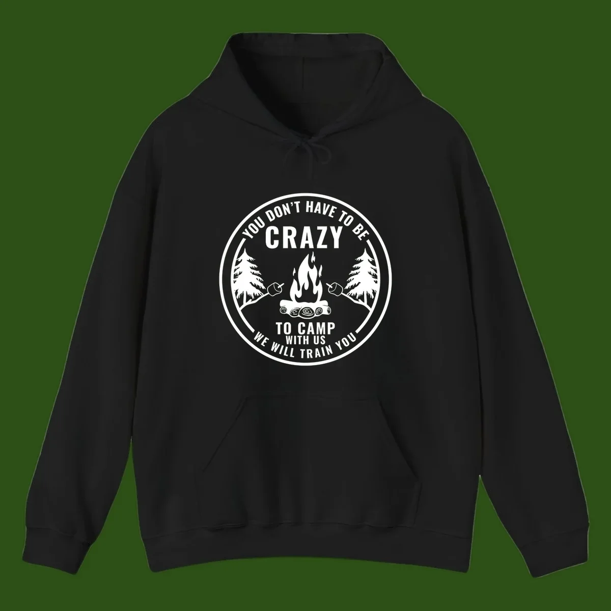 Circular badge design with campfire, pine trees, and marshmallows on sticks with humorous camping text about training crazy campers