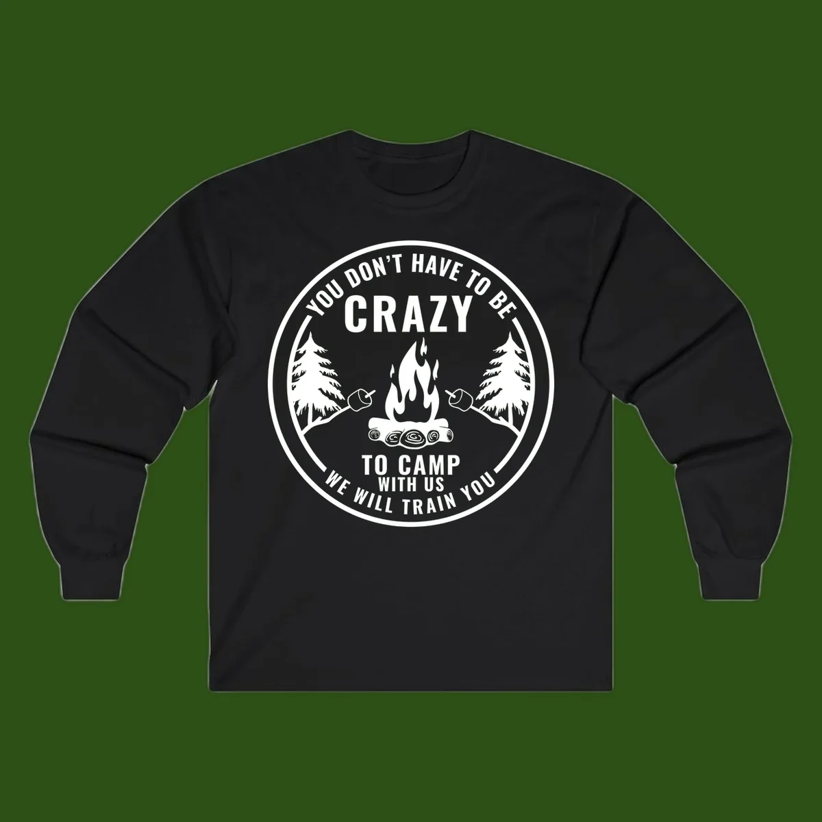 Circular badge design with campfire, pine trees, and marshmallows on sticks with humorous camping text about training crazy campers
