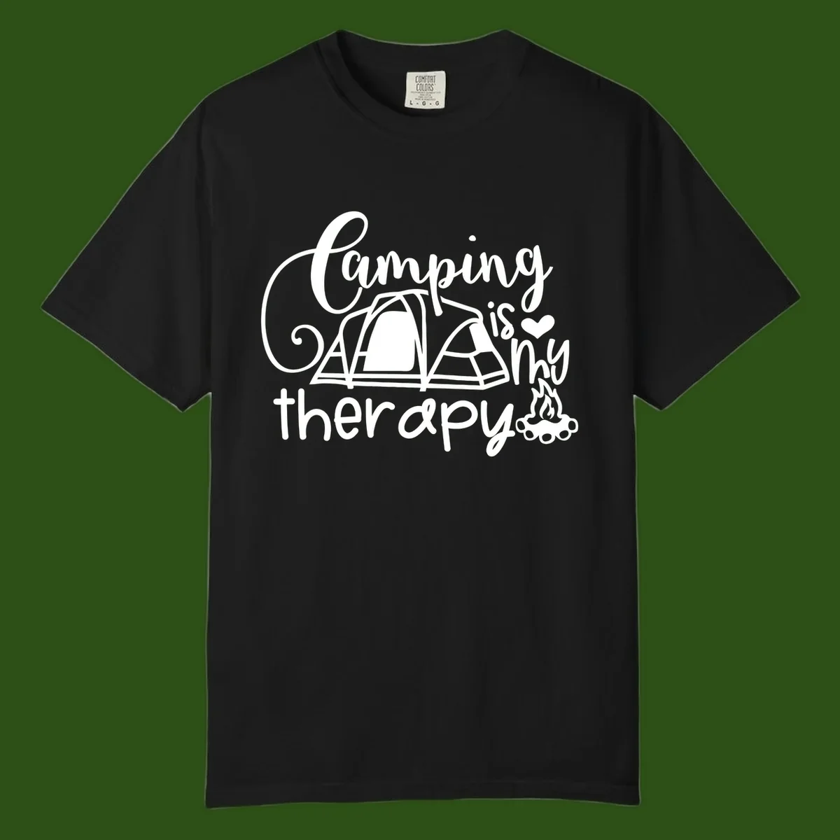White lettered design reading 'Camping is Therapy' with heart symbol, tent, and campfire illustration on gray background