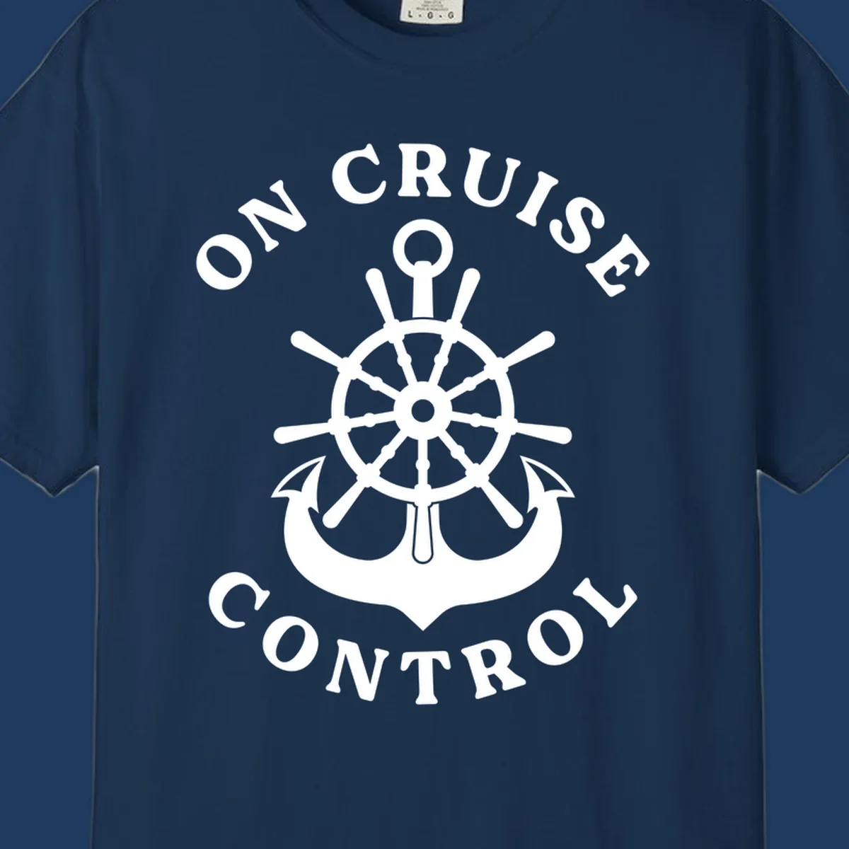 On cruise control nautical badge with ship wheel, anchors, crown and shield design in white on gray background.