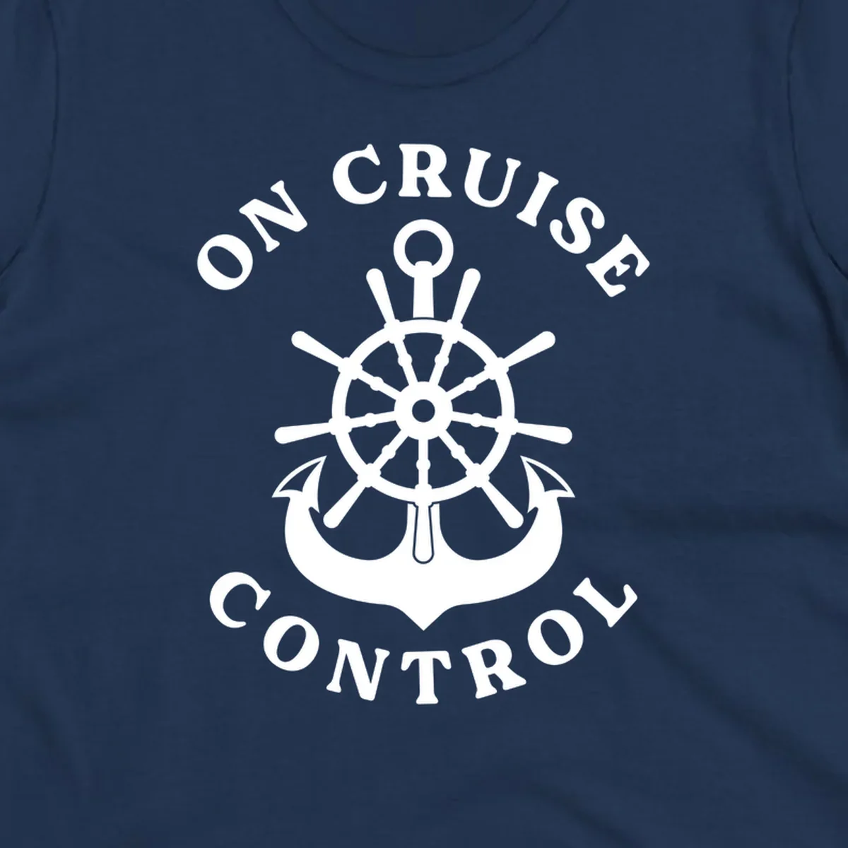 On cruise control nautical badge with ship wheel, anchors, crown and shield design in white on gray background.