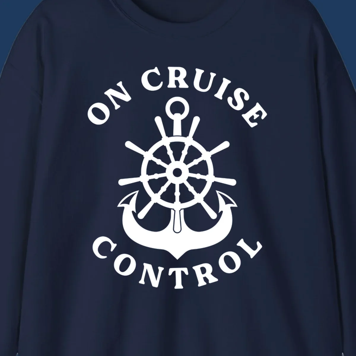 On cruise control nautical badge with ship wheel, anchors, crown and shield design in white on gray background.