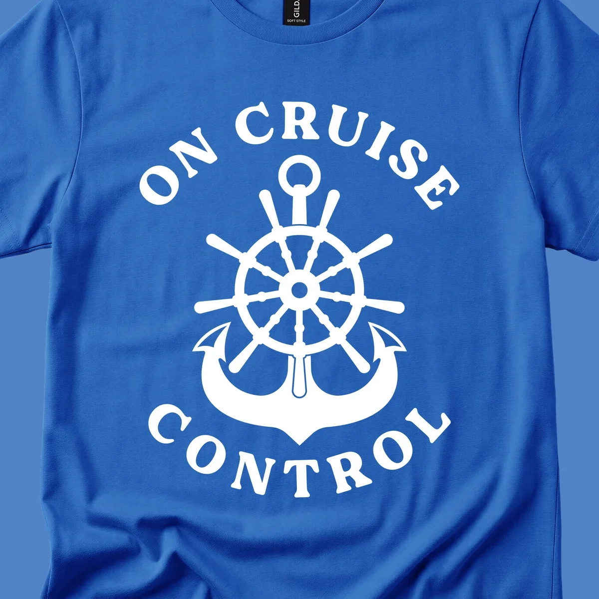 On cruise control nautical badge with ship wheel, anchors, crown and shield design in white on gray background.