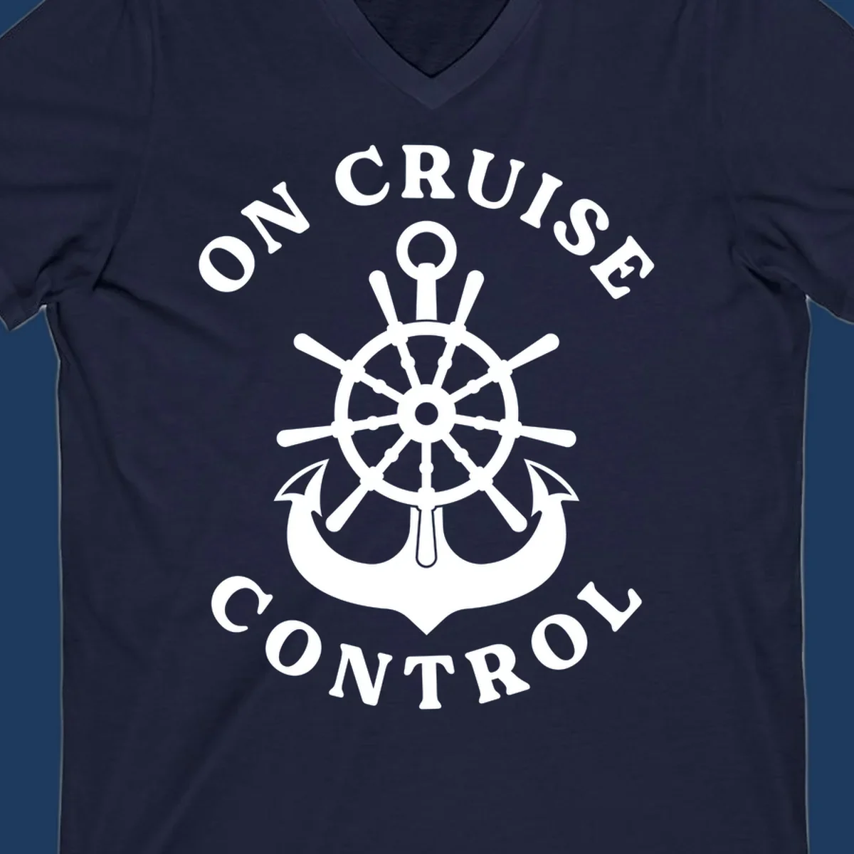On cruise control nautical badge with ship wheel, anchors, crown and shield design in white on gray background.