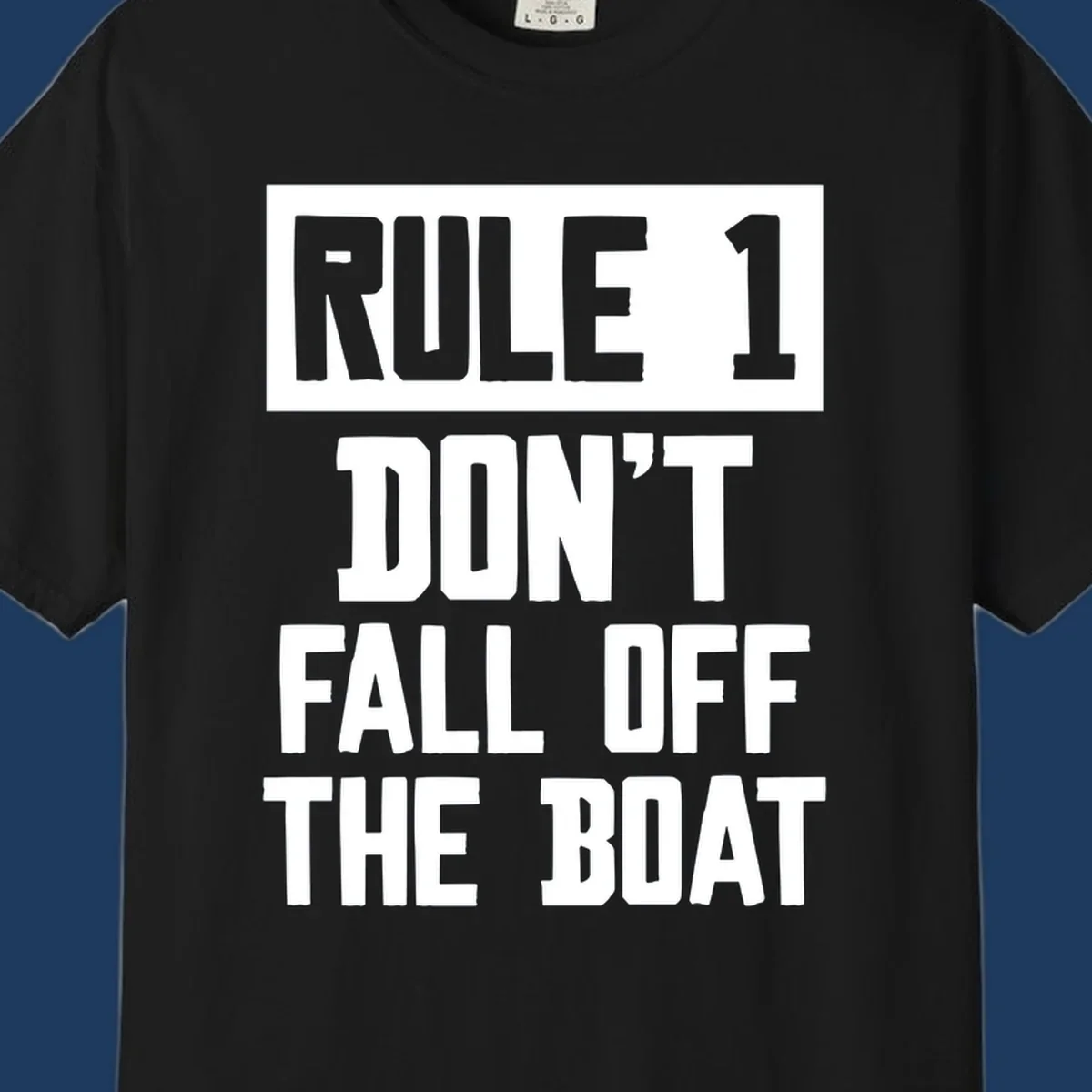 Bold gray and white typography reading 'Rule 1 Don't Fall Off The Boat' - a humorous nautical design