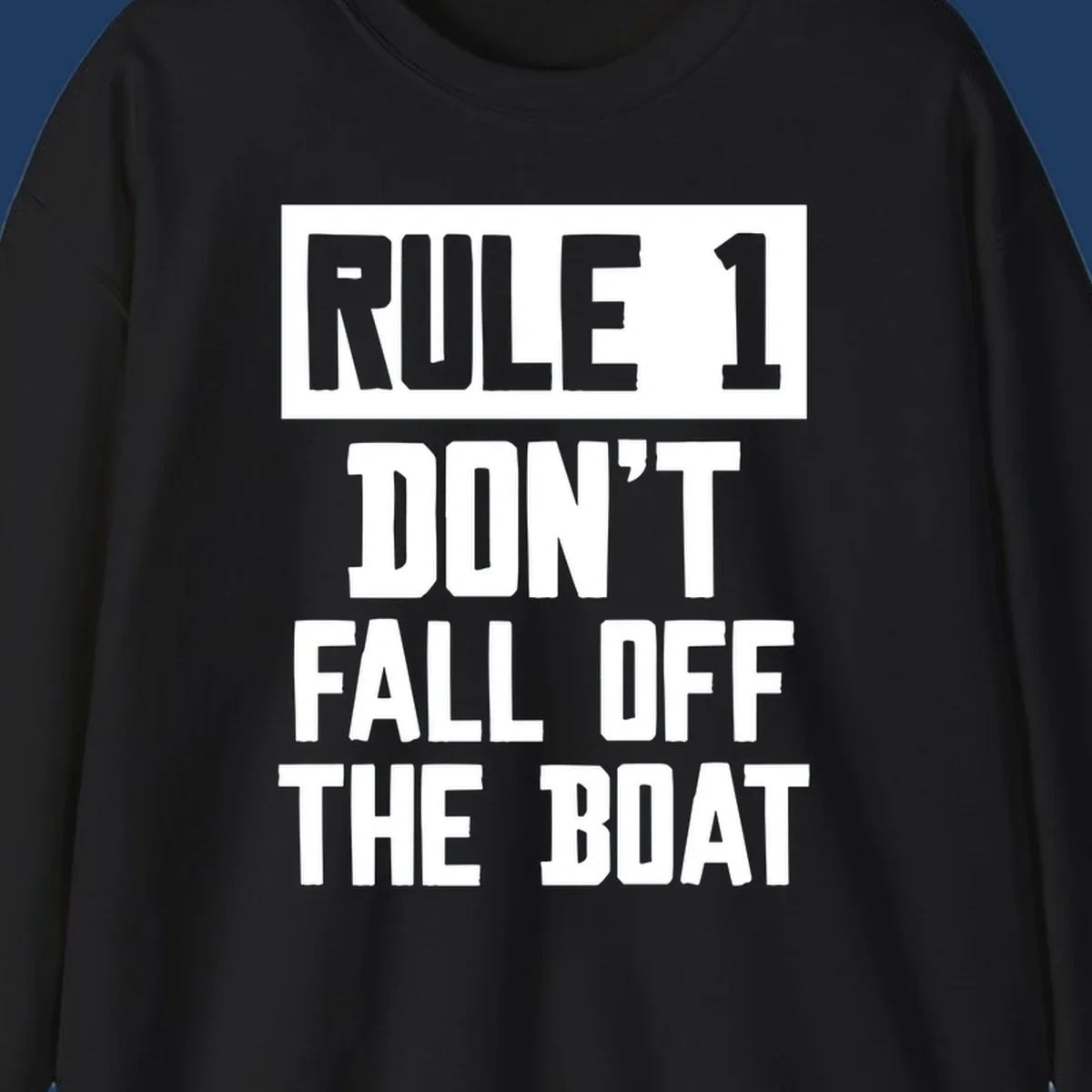 Bold gray and white typography reading 'Rule 1 Don't Fall Off The Boat' - a humorous nautical design