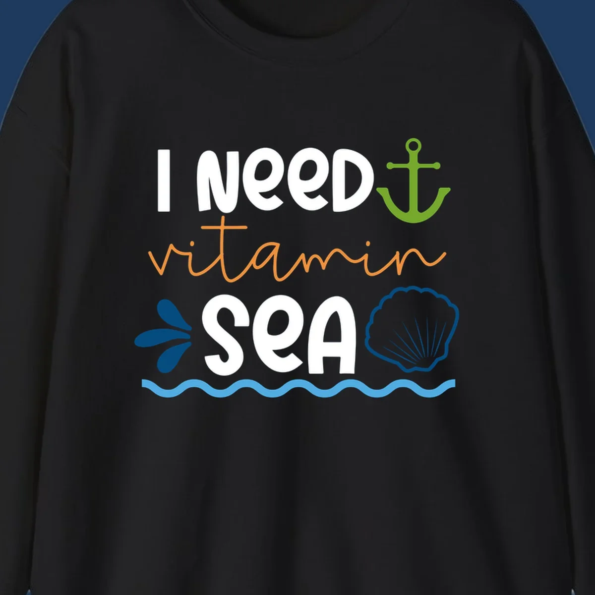 Nautical design with 'I NEED vitamin SEA' text, green anchor, orange waves, blue shell and water droplets on gray background